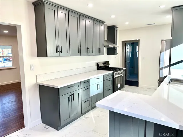 a kitchen with a sink stove and cabinets