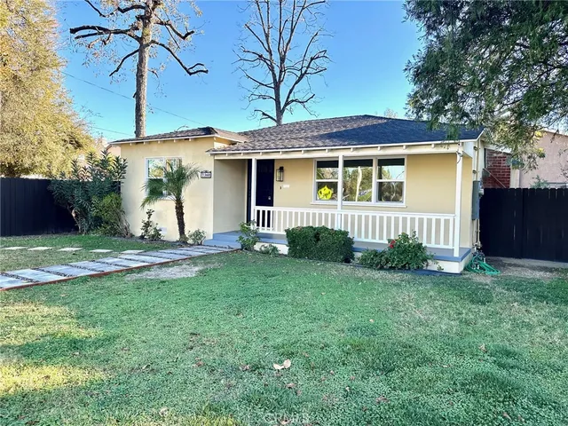 a front view of a house with a garden and yard