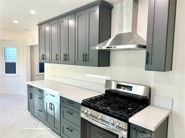 a kitchen with stainless steel appliances a stove a microwave and a refrigerator