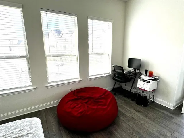 a room with a window and wooden floor