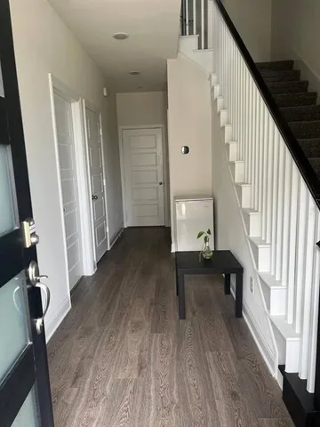 a view of entryway with wooden floor and stairs