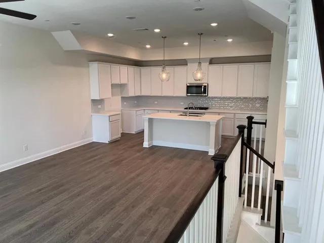 a kitchen with a sink appliances and cabinets