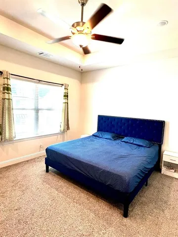 a bed sitting in a room next to a window