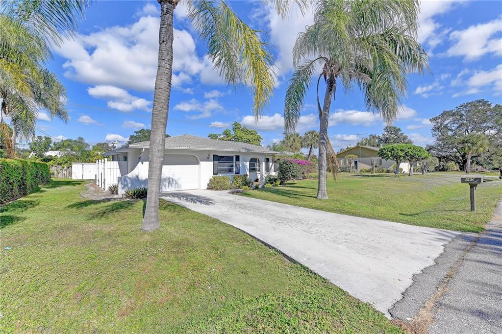 165 Oneida Road Venice, FL 34293 - Photo 1 of 1 a house with palm tree in the background