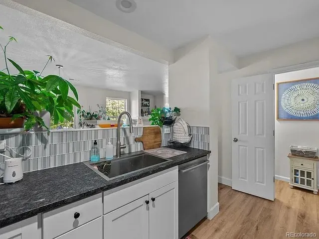 a kitchen with sink and cabinets