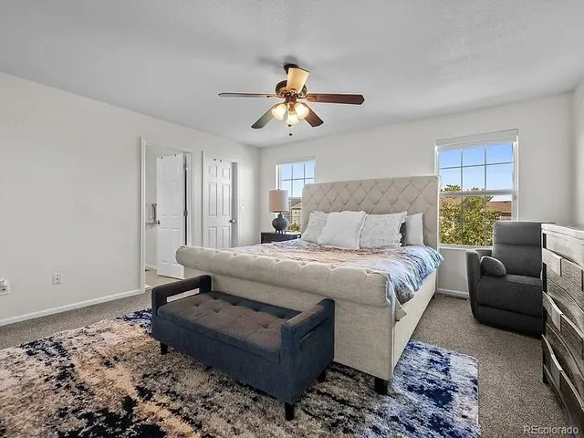 a bedroom with a bed couch and window