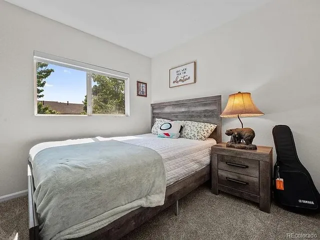 a bedroom with a bed and a lamp on table