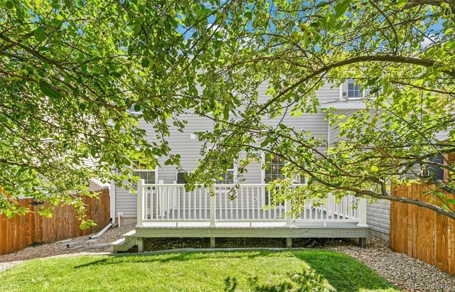 a view of a chair and table in the backyard