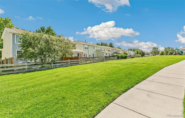 a view of a garden with a building in the background