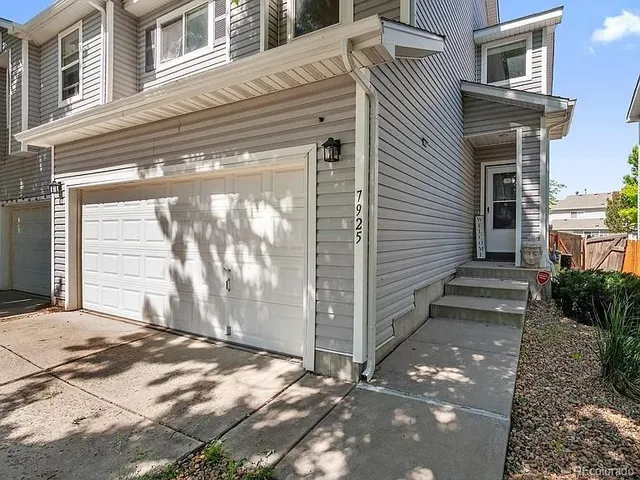 a view of a house with a door and wooden walls