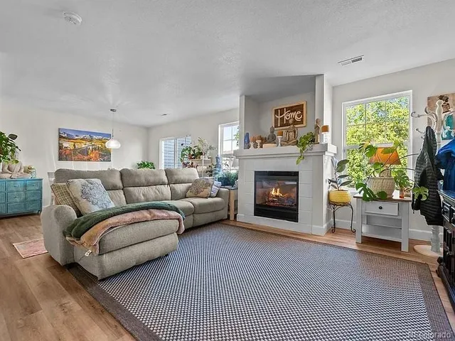 a living room with furniture and a fireplace