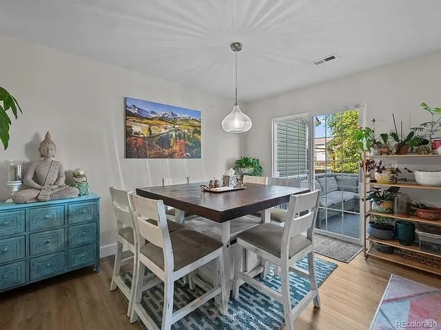 a view of a dining room with furniture window and wooden floor