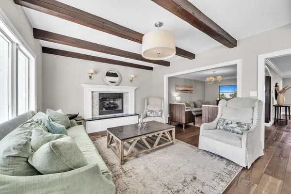 a spacious bedroom with a bed and a chandelier