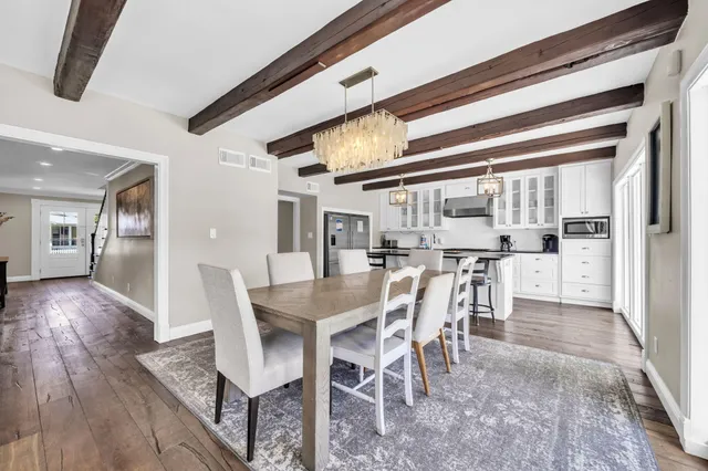 a spacious bathroom with a double vanity sink a mirror and a bathtub