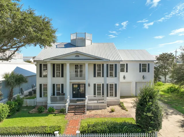 a view of a house with swimming pool and sitting area