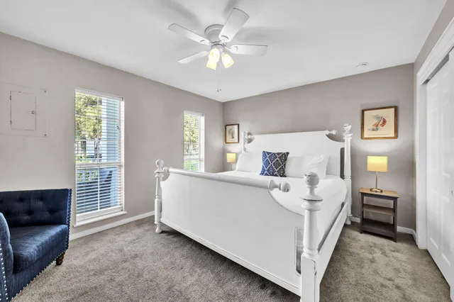 a bedroom with a large bed and a chandelier