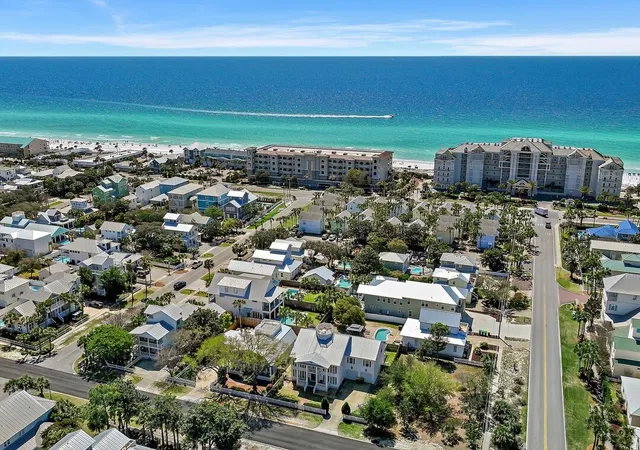 a kitchen with stainless steel appliances granite countertop a stove a sink dishwasher and cabinets with wooden floor