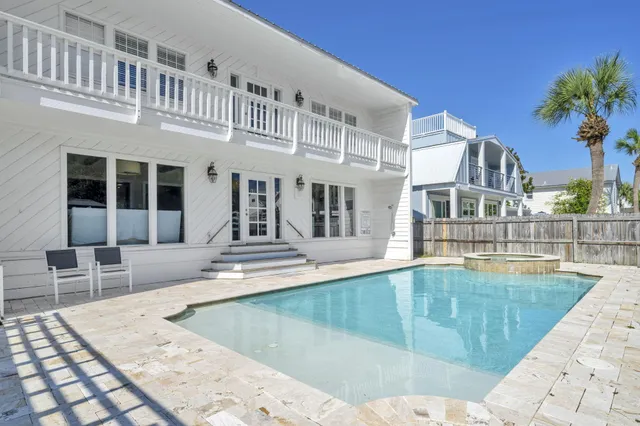 a kitchen with granite countertop a table chairs stove and cabinets
