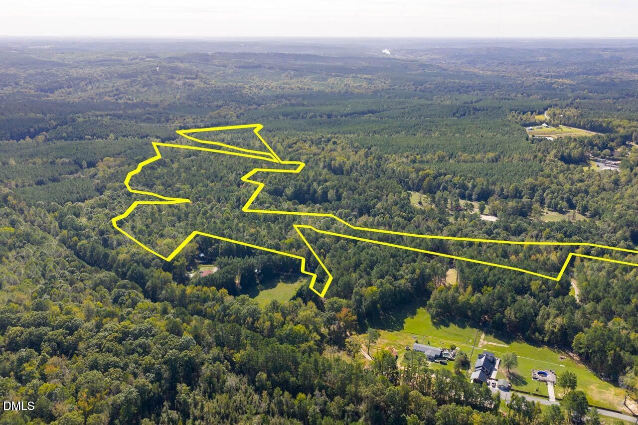 262 Ellis Road Moncure, NC 27559 - Photo 1 of 29 an aerial view of a house with a swimming pool outdoor seating and yard