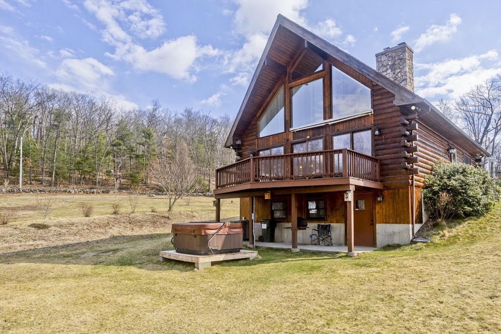 a view of a house with pool and sitting area
