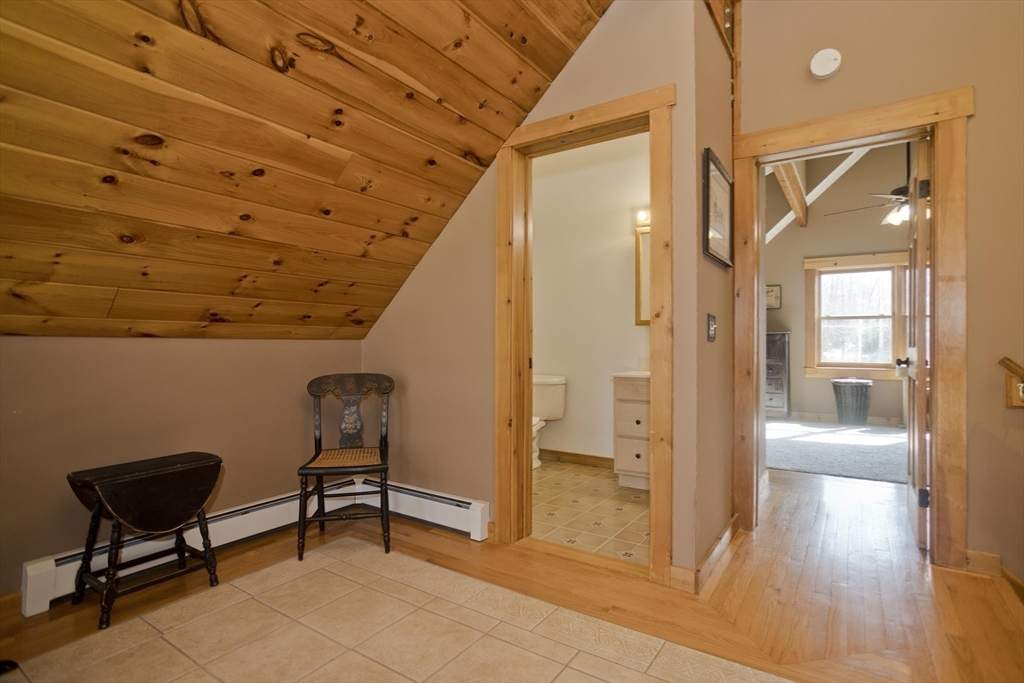 2136 Baptist Hill Road Palmer, MA 01069 - Photo 13 of 41 a view of a hallway with wooden floor and furniture