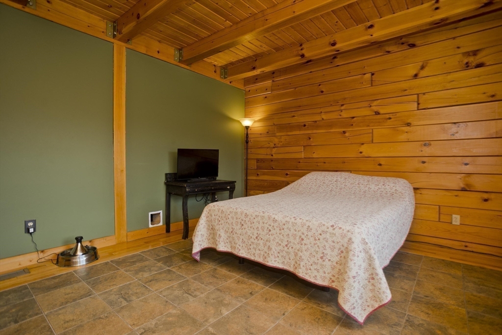 2136 Baptist Hill Road Palmer, MA 01069 - Photo 20 of 41 a bedroom with a bed and a flat screen tv