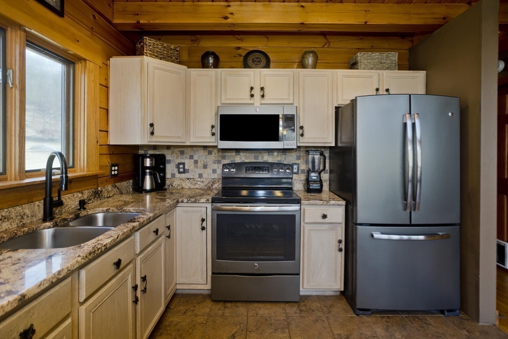 2136 Baptist Hill Road Palmer, MA 01069 - Photo 6 of 41 a kitchen with stainless steel appliances granite countertop a refrigerator a stove and a sink