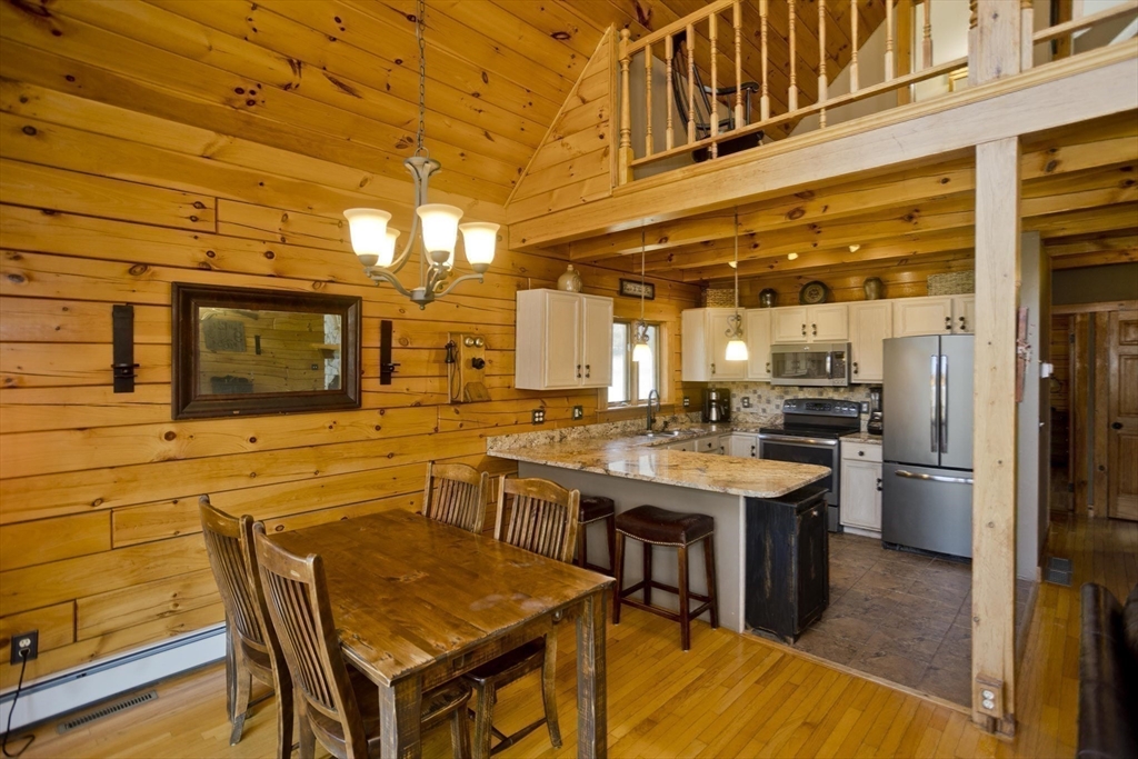 2136 Baptist Hill Road Palmer, MA 01069 - Photo 7 of 41 a view of a kitchen with a table and chairs