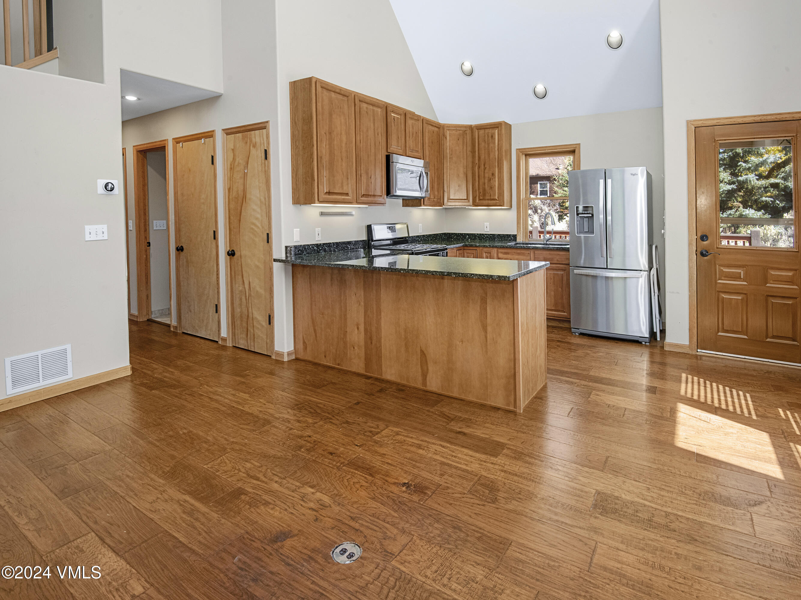 490 Neilson Gulch Road Eagle, CO 81631 - Photo 16 of 55 a kitchen with stainless steel appliances granite countertop a refrigerator and a stove top oven