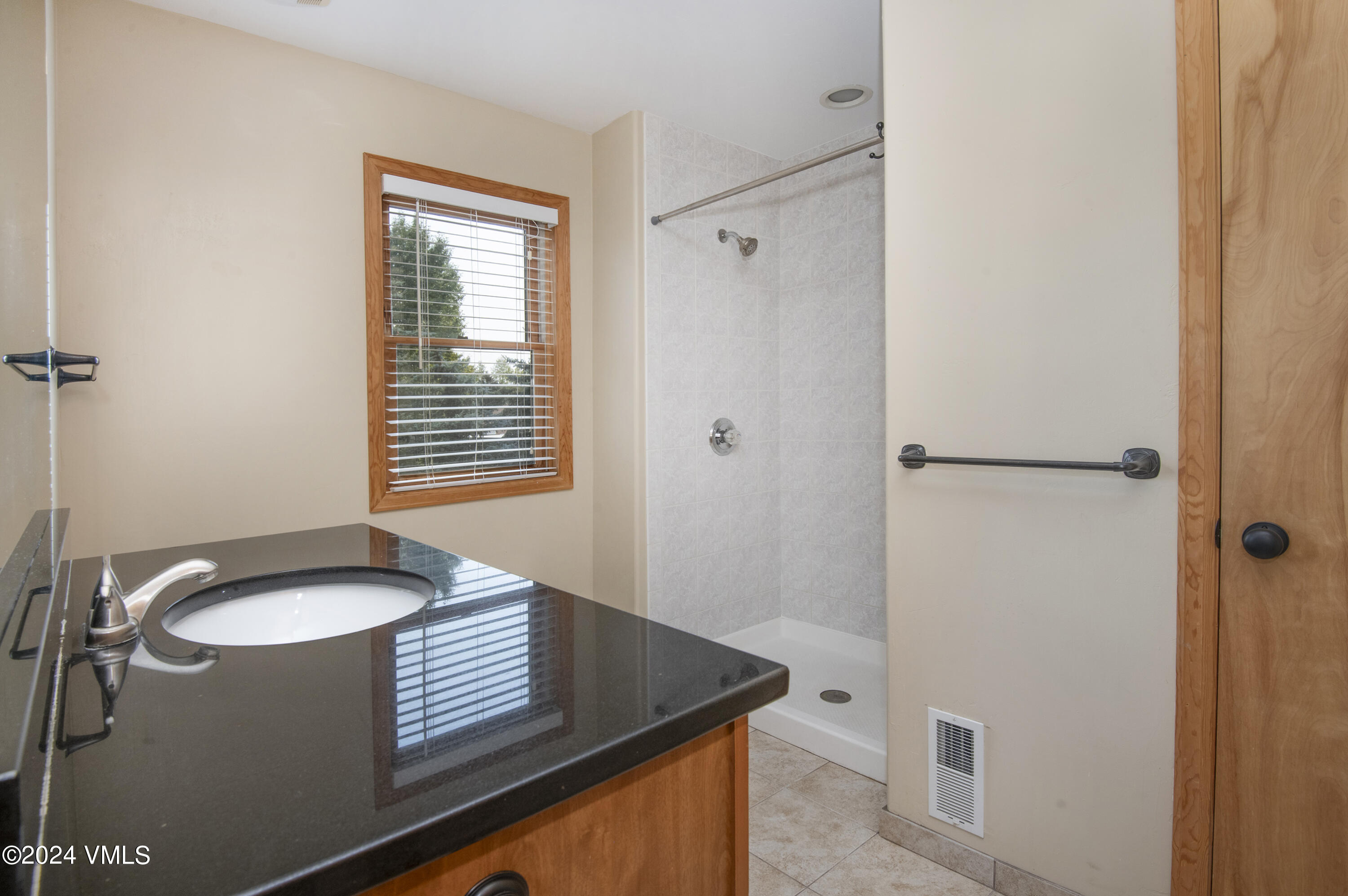 490 Neilson Gulch Road Eagle, CO 81631 - Photo 20 of 55 a bathroom with a granite countertop sink and a mirror