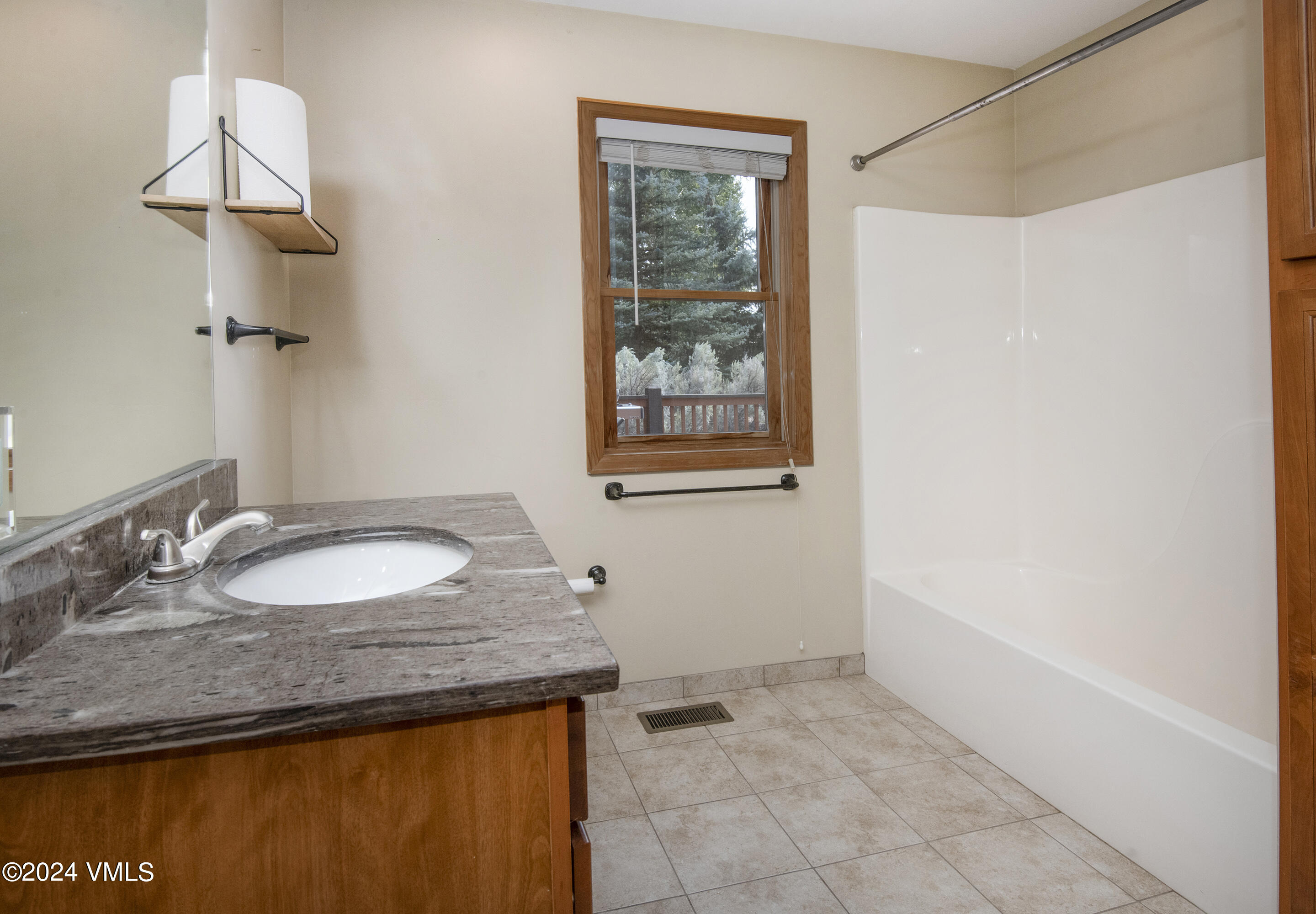 490 Neilson Gulch Road Eagle, CO 81631 - Photo 23 of 55 a bathroom with a granite countertop sink and a mirror