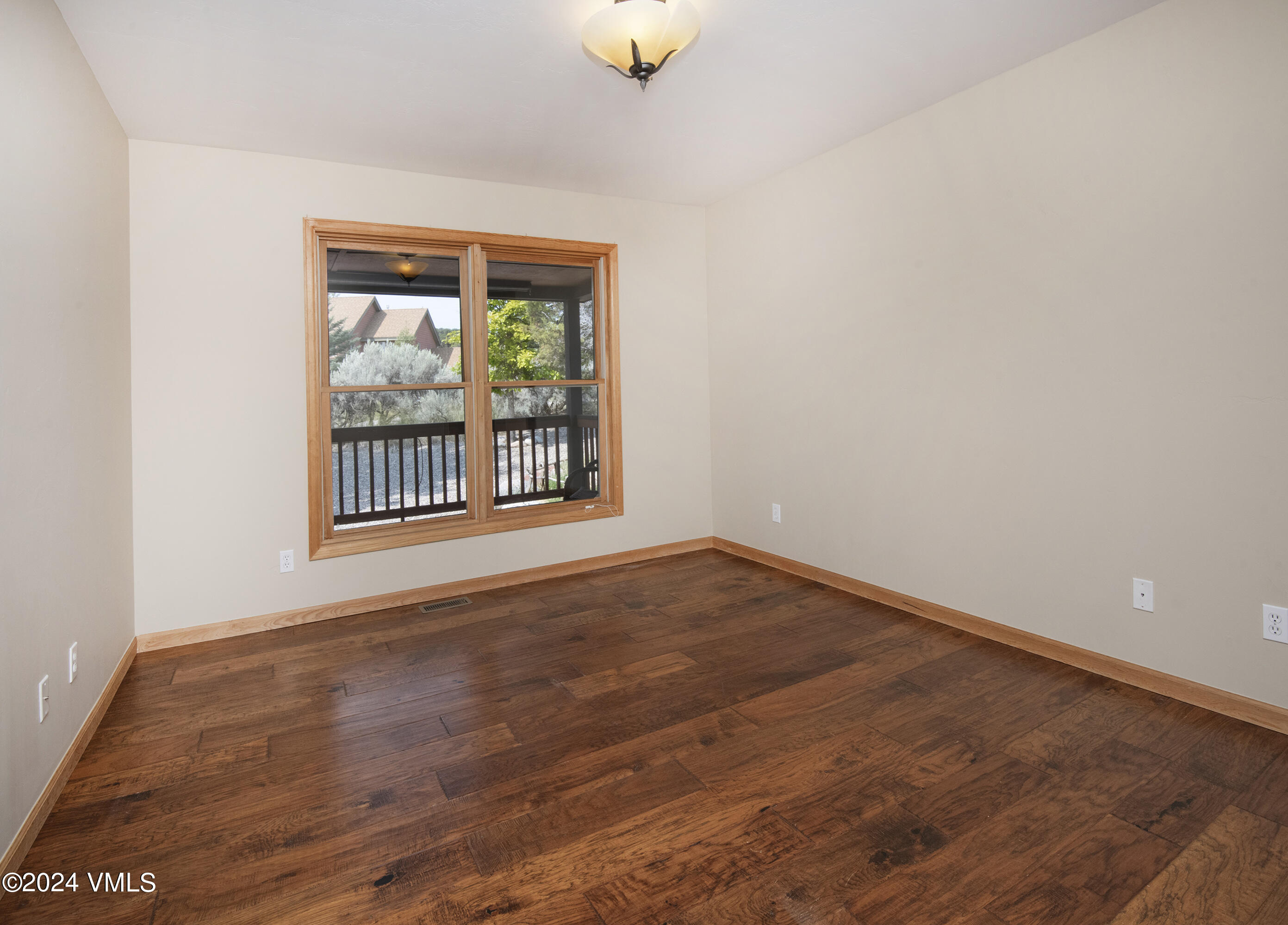 490 Neilson Gulch Road Eagle, CO 81631 - Photo 27 of 55 an empty room with wooden floor and windows