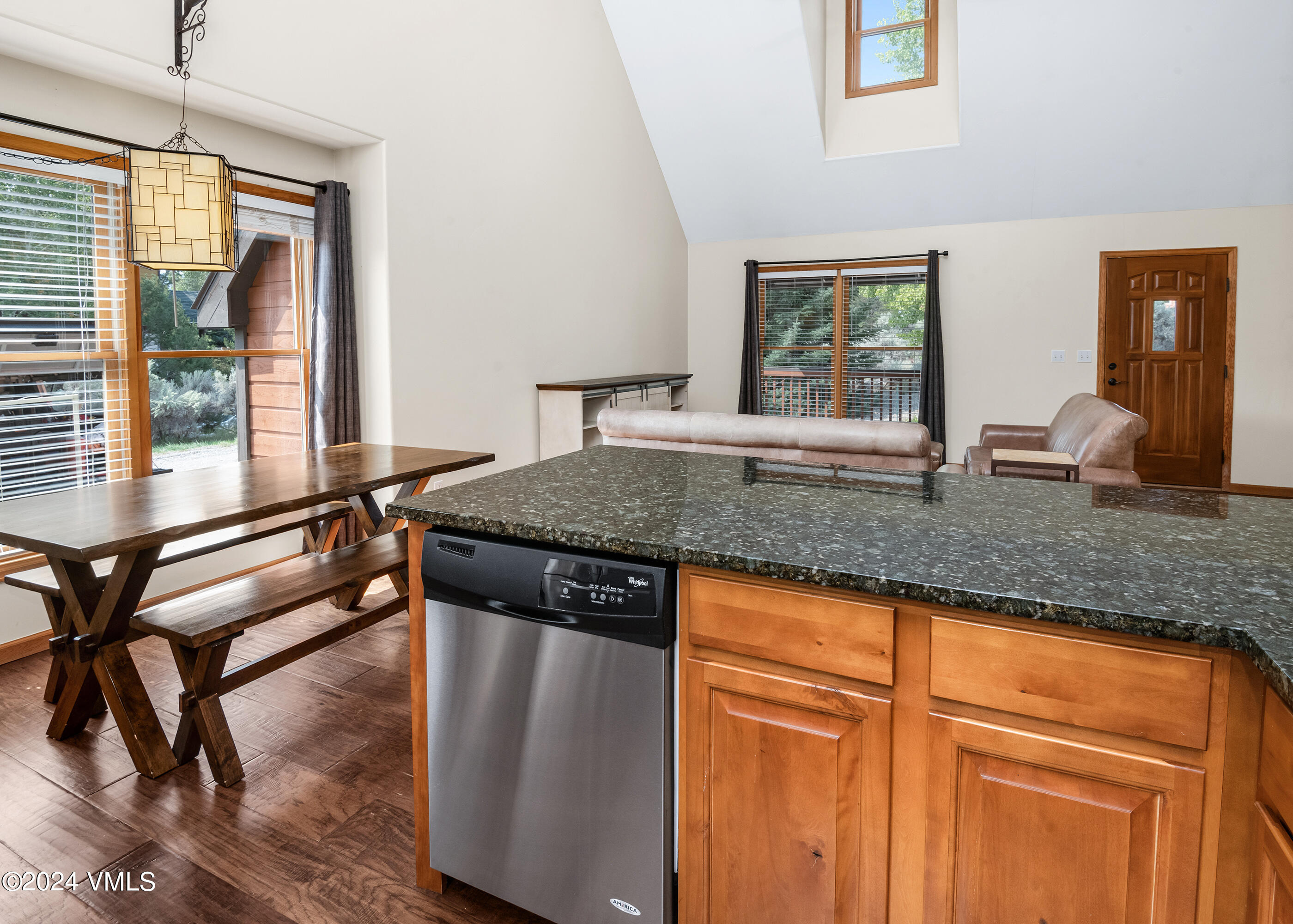 490 Neilson Gulch Road Eagle, CO 81631 - Photo 8 of 55 a kitchen with granite countertop wooden cabinets dining table and chairs