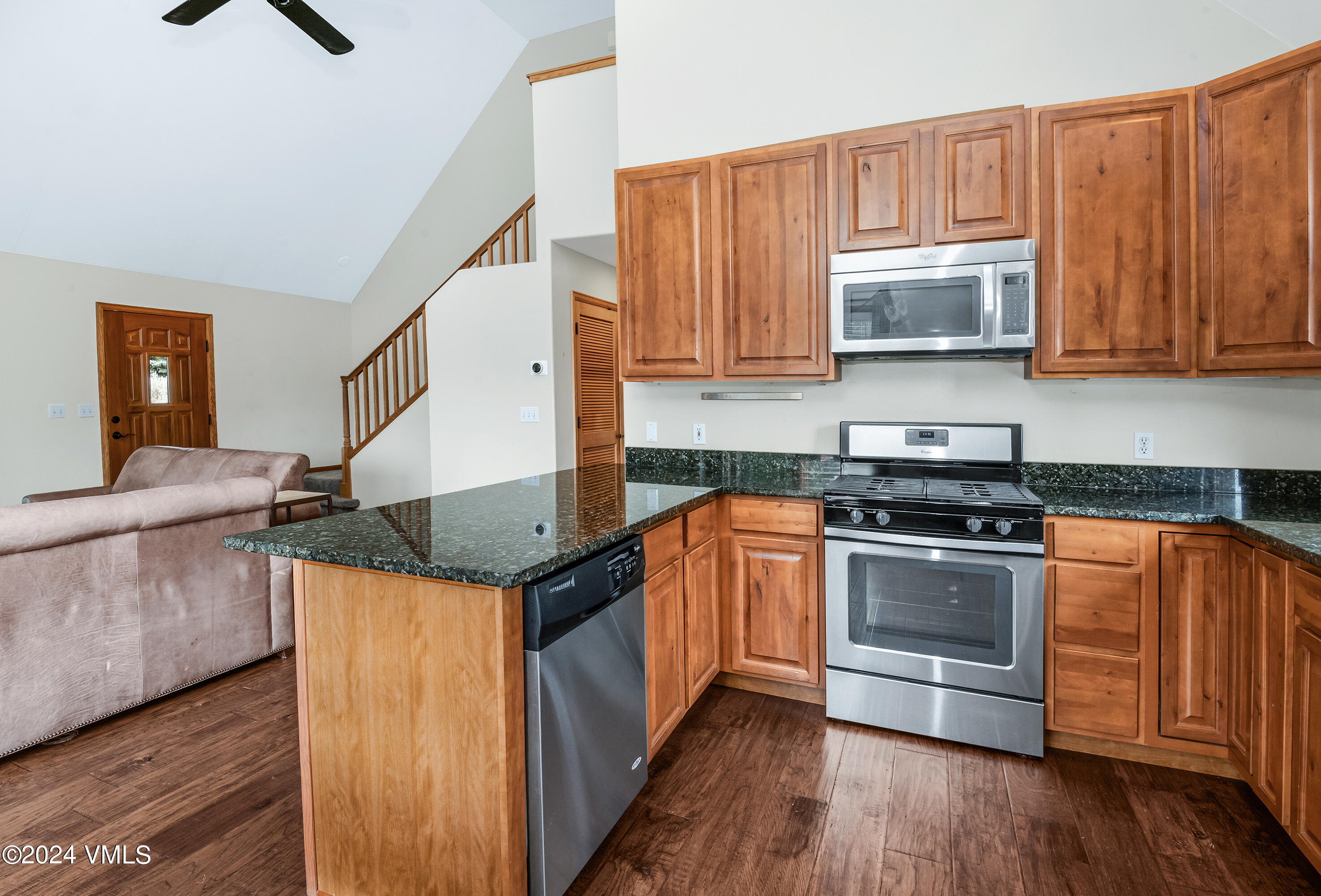 490 Neilson Gulch Road Eagle, CO 81631 - Photo 9 of 55 a kitchen with stainless steel appliances granite countertop a stove a sink and a microwave