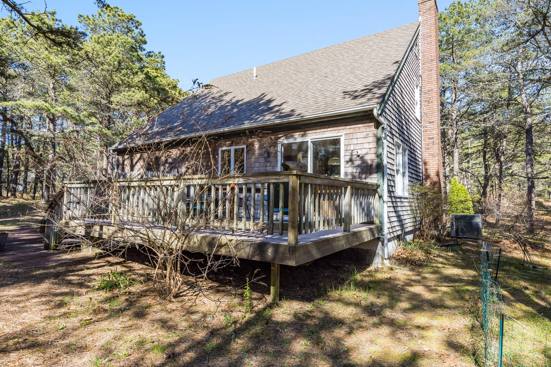 35 Sea Pine Road Wellfleet, MA 02667 - Photo 31 of 36 a view of a house with a wooden deck and a yard