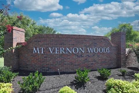 a living room with furniture a chandelier and a floor to ceiling window