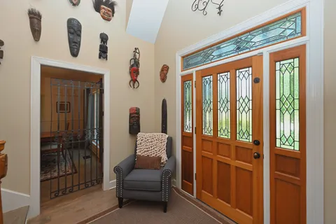a living room with fireplace furniture and a book shelf
