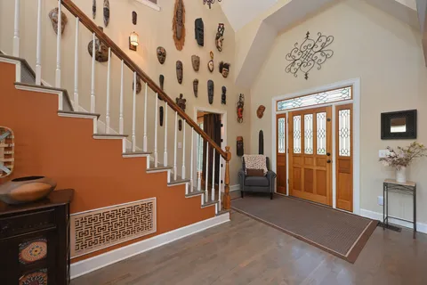 a view of a hallway with entryway wooden floor and front door