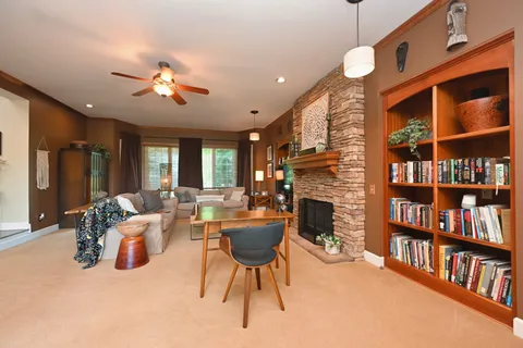 a kitchen with stainless steel appliances granite countertop a sink dishwasher a refrigerator and a stove with wooden floor