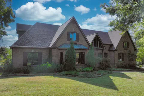 a front view of a house with garden