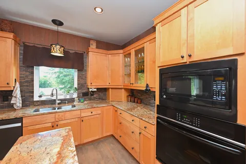 a living room with fireplace furniture and a large window