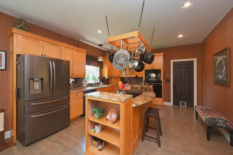 a dining room with furniture a chandelier and window