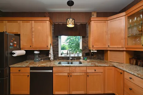 a view of a workspace with furniture and a window