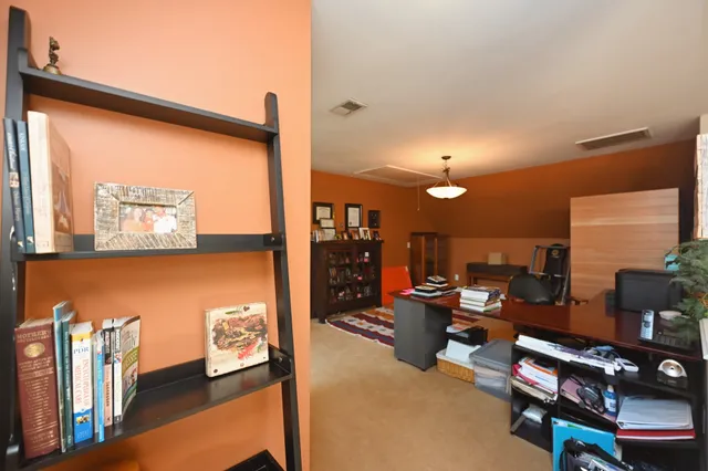a living room with a bed furniture and a flat screen tv