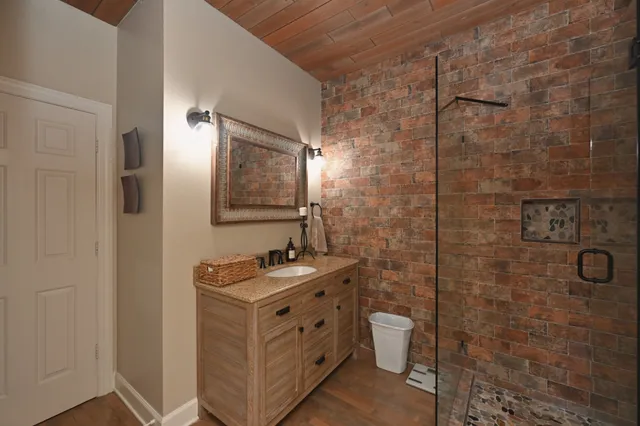 a bedroom with a bed mirror and couch