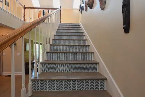 a room with stainless steel appliances kitchen island granite countertop a stove and a sink