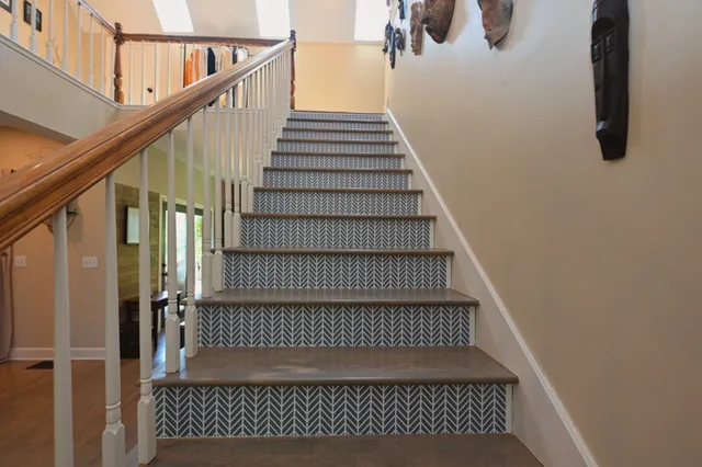 a room with stainless steel appliances kitchen island granite countertop a stove and a sink