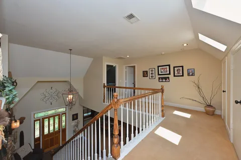 a bathroom with a toilet sink vanity and mirror