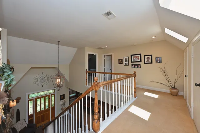 a bathroom with a toilet sink vanity and mirror