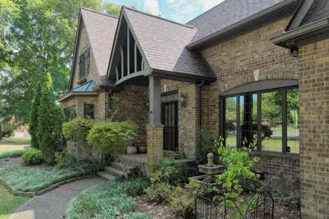a view of a garden with large trees